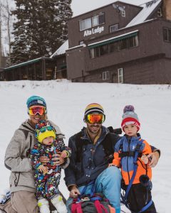 Family Playing in Snow Outside of Alta Lodge