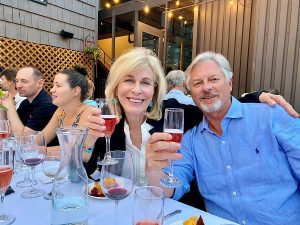 couple toasting with pink champagne on Alta Lodge patio